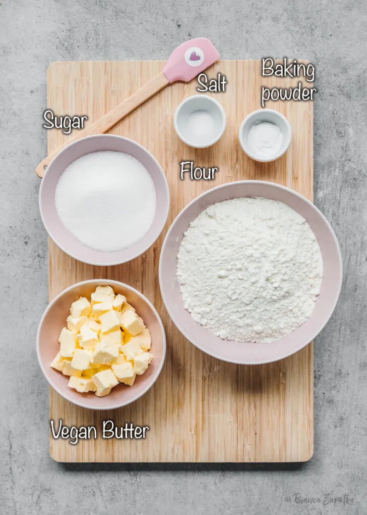 Flour, sugar, vegan butter, salt, and baking powder for vegan baking recipe
